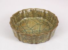 A GOOD CHINESE SONG STYLE BRUSH WASH, with crackle style glaze and moulded edges, and incised gilt