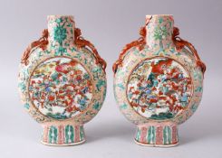 A PAIR OF 19TH CENTURY CHINESE FAMILLE ROSE PORCELAIN WARRIOR MOON FLASKS, with moulded chilong,