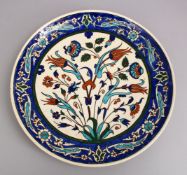A GOOD LARGE IZNIK POTTERY DISH, decorated with floral decoration. 38cm.