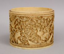 A 19TH CENTURY JAPANESE CARVED IVORY TUSK SECTION, depicting cranes and cherry blossom, 8cm.
