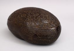 A GOOD 19TH CENTURY ISLAMIC CARVED CALLIGRAPHIC COCO KASHKOOL, carved with flora and panels of