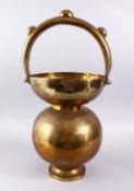 A LARGE 19TH / 20TH CENTURY ISLAMIC BRASS SPITTOON, with figures and raised bosses, 56cm x 28cm.