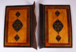 A GOOD 19TH CENTURY PERSIAN LACQUER BOOK COVERS, painted with bands of calligraphy and floral
