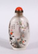 A CHINESE REVERSE PAINTED GLASS SNUFF BOTTLE, depicting birds amongst flora, with a hard stone