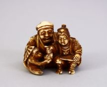 A JAPANESE MEIJI PERIOD CARVED IVORY OKIMONO - MAN & MONKEY, the seated monkey keeper seated aside