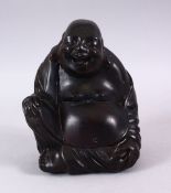 A CHINESE CARVED HARDWOOD / HONGMU FIGURE OF A SEATED BUDDHA, with a humorous expression and one