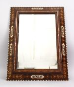 A 19TH CENTURY SPANISH MORESQUE INLAID CALLIGRAPHIC WOODEN MIRROR, the frame with exotic wood inlay,