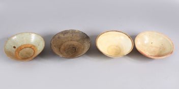 A LOT OF FOUR EARLY CHINESE POTTERY BOWLS, some glazed some unglazed. largest: 15.5cm