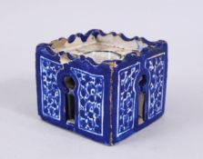 A GOOD EARLY PERSIAN POTTERY INKWELL, with cobalt blue ground with floral decoration, 6.5cm square.