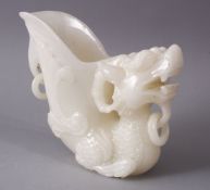 A 29TH CENTURY CHINESE CARVED WHITE JADE LIBATION CUP OF A LION DOG, 14cm high.