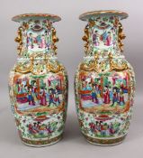 A PAIR OF 19TH CENTURY CHINESE CANTON FAMILLE ROSE PORCELAIN VASES, the white ground with panel