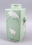 A GOOD CHINESE CELADON TWIN HANDLE SQUARE FORMED PORCELAIN CRANE VASE, the body with carved