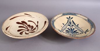 TWO 19TH CENTURY TURKISH CANAKKALE POTTERY BOWLS, decorated with stylized flora, 20cm & 21cm.