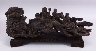 A GOOD CHINESE HARDWOOD CARVED FIGURE OF SHOU LAO AND TWO BOYS WITH PEACH, carved in naturalistic