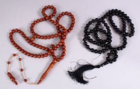 TWO GOOD TURKISH ZIKIR CARVED TESBIH, one long kuka 113cm long, and one black carved kehlibar 75cm.