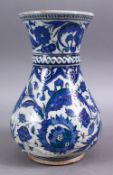A GOOD PERSIAN 19TH CENTURY BLUE & GREEN DECORATED POTTERY VASE, with formal scrolling flora, and