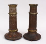 A PAIR OF 19TH CENTURY PERSIAN QAJAR TORCH STANDS / CANDLESTICKS, decorated with formal foliage