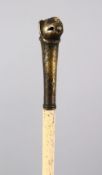 A 19TH CENTURY INDIAN MUGHAL TIGER HEAD MOUNTED WHALE BONE SWAGGER STICK, 82cm.