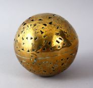 A 19TH CENTURY INDIAN BRASS HAND WARMER, with open work, 10cm diameter.