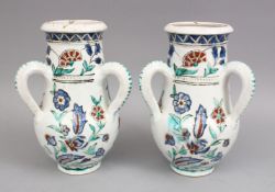 A PAIR OF IZNIK STYLE POSS EUROPEAN POTTERY TRIPLE HANDLED VASES, each vase with three moulded