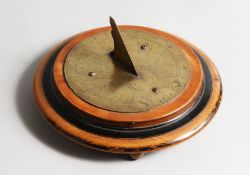 AN EARLY BRASS CIRCULAR SUNDIAL DATED 1727. 5ins diameter.