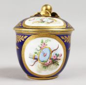 A SMALL SEVRES RICH BLUE GROUND BOWL AND COVER, painted with cupids and trophies. Sevres mark in