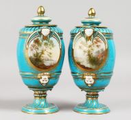A VERY GOOD PAIR OF 19TH CENTURY SEVRES BLUE VASES AND COVERS, with masks and reverse panels of a