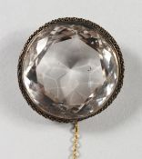A LARGE CUT CIRCULAR CRYSTAL BROOCH.