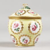A SMALL SEVRES PALE YELLOW GROUND BOWL AND COVER painted with roses. 3.5ins high.