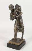 A BRONZE FIGURE OF AN ARAB MAN WITH A STICK, carrying a water bottle on his back. 9.5ins high.