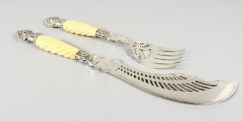 A VERY GOOD PAIR OF PIERCED AND ENGRAVED FISH SERVERS with ivory handles.