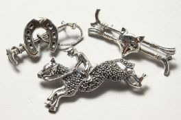 THREE SILVER HORSE BROOCHES.