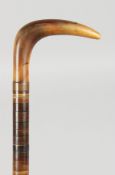 A GOOD RHINO HANDLED SEGMENTED WALKING STICK. 34ins long.