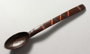 A TRIBAL SPOON. 14ins long.