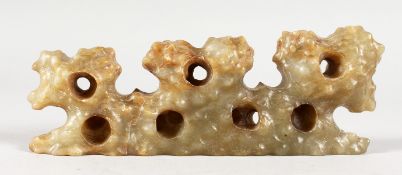 A CARVED JADE BRUSH REST. 7ins long.
