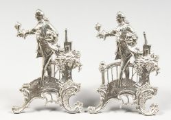 TWO PIERCED AND EMBOSSED SILVER FIGURAL STANDS. 3.5ins high.