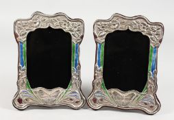 A PAIR OF ART NOUVEAU STYLE SILVER PHOTOGRAPH FRAMES, with enamel decoration, embossed with a