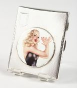 AN ENGINE TURNED SILVER CIGARETTE CASE, with a circular panel of a model clapping hands.