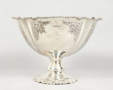 A SILVER PEDESTAL FRUIT BOX, repousse with scrolls and flowers. Sheffield 1909. Maker: FBS LTD.