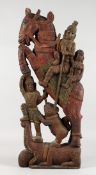 A LARGE INDIAN CARVED AND PAINTED WOOD GROUP, figures on a horseback. 31ins high x 12ins wide.