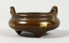 A CHINESE MINIATURE GOLD SPLASH BRONZE CENSER. 2.5ins diameter.