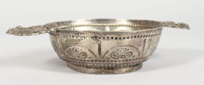 A CONTINENTAL SILVER TWO-HANDLED BOWL, the handles as Heraldic crests. 4.5ins diameter.