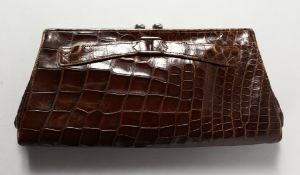 A BROWN CROCODILE LEATHER HANDBAG.