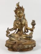 A THAI GILT BRONZE SEATED FEMALE DEITY. 8.5ins high.