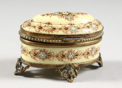 A SMALL PORCELAIN DECORATED OVAL JEWELLERY BOX. TAHAN LABEL, PARIS. 3ins long.
