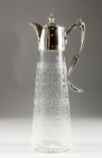A HAND ENGRAVED GLASS CLARET JUG with plated mounts and handle.