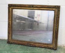 AN 18TH/19TH CENTURY GILT FRAMED MIRROR, the frame with moulded floral decoration and original