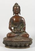 A CHINESE BRONZE BUDDHA SEATED IN THE LOTUS POSITION. 11.5ins high.