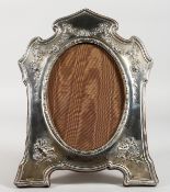 A LARGE SILVER PHOTOGRAPH FRAME, repousse with garlands of roses and musical trophies. 12.5ins x