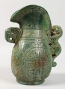A CHINESE ARCHAIC STYLE CARVED JADE EWER. 8ins high.
